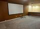 Spacious carpeted living room with brown walls and a movie screen at 12610 Sawgrass Oak St, Orlando, FL 32824