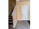 Entry staircase featuring mosaic tile accents, neutral walls, and a solid door at 12610 Sawgrass Oak St, Orlando, FL 32824