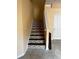 Staircase featuring mosaic tile accents and neutral walls at 12610 Sawgrass Oak St, Orlando, FL 32824