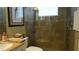 Bathroom showcasing a glass enclosed shower with decorative stone accents at 13016 Islamorada Dr, Orlando, FL 32837