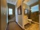 Bathroom and hallway showcases earth-tone paint and flooring at 13016 Islamorada Dr, Orlando, FL 32837