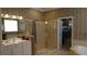 An elegant bathroom with a glass shower, double vanity, and an organized walk-in closet at 13016 Islamorada Dr, Orlando, FL 32837