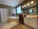 Bathroom featuring a tub, stand up shower, and a double vanity at 13016 Islamorada Dr, Orlando, FL 32837