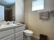 Clean bathroom with neutral paint, white vanity, and tile flooring, offering a functional and inviting space at 13016 Islamorada Dr, Orlando, FL 32837