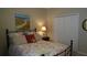 Bedroom features a metal bed frame, seascape art, and starfish accent at 13016 Islamorada Dr, Orlando, FL 32837