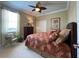 Cozy bedroom with a floral bedspread, a side chair, a dresser, and neutral-toned walls at 13016 Islamorada Dr, Orlando, FL 32837