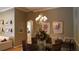 Cozy dining room with modern chandelier, seating for six, and decorative wall art at 13016 Islamorada Dr, Orlando, FL 32837