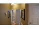 Hallway with neutral paint, framed art, and doors leading to other rooms at 13016 Islamorada Dr, Orlando, FL 32837