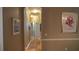 Hallway with hardwood floors, neutral paint, framed art, and architectural details at 13016 Islamorada Dr, Orlando, FL 32837