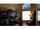 Dedicated home office with large windows, built-in shelving, and a comfortable work space at 13016 Islamorada Dr, Orlando, FL 32837