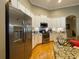 This eat-in kitchen features granite countertops and stainless steel appliances with white cabinets at 13016 Islamorada Dr, Orlando, FL 32837