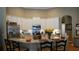 Bright kitchen featuring white cabinetry, granite countertops, and stainless steel appliances at 13016 Islamorada Dr, Orlando, FL 32837