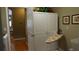 A well-organized laundry room featuring built-in storage and an ironing board for added convenience at 13016 Islamorada Dr, Orlando, FL 32837
