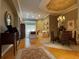 Well-lit living room and dining area with hardwood floors, an elegant chandelier, and neutral décor at 13016 Islamorada Dr, Orlando, FL 32837