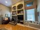 Charming living room featuring a stone fireplace and built-in shelving at 13016 Islamorada Dr, Orlando, FL 32837