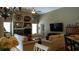 Living room with a stone fireplace, built-in shelves, a large TV, and comfortable seating at 13016 Islamorada Dr, Orlando, FL 32837