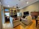Spacious living area featuring a stone fireplace, high ceilings, and ample seating at 13016 Islamorada Dr, Orlando, FL 32837