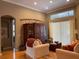 Bright living area with a large cabinet, hardwood floors, neutral walls, and comfortable seating at 13016 Islamorada Dr, Orlando, FL 32837