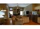 A combined kitchen and living room with granite countertops, stainless steel appliances, and hardwood floors offer modern comfort at 13016 Islamorada Dr, Orlando, FL 32837