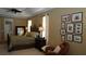 A luxurious main bedroom with decorative headboard, plush bedding, and ample natural light at 13016 Islamorada Dr, Orlando, FL 32837