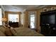 A luxurious main bedroom with decorative headboard, plush bedding, and ample natural light at 13016 Islamorada Dr, Orlando, FL 32837