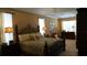 A luxurious main bedroom with decorative headboard, plush bedding, and ample natural light at 13016 Islamorada Dr, Orlando, FL 32837