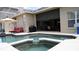 Backyard pool area with a nearby outdoor kitchen and ample space for relaxation at 13016 Islamorada Dr, Orlando, FL 32837
