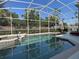 Inviting screened-in pool with spa and ample space for relaxation and enjoyment at 13016 Islamorada Dr, Orlando, FL 32837