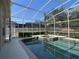 Screened-in pool and spa with mature landscaping and privacy fence at 13016 Islamorada Dr, Orlando, FL 32837