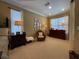 Sitting area featuring a dresser, accent chair, and natural light from large windows at 13016 Islamorada Dr, Orlando, FL 32837