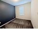 Carpeted bedroom with one window, light walls, and a dark accent wall at 1308 Shinnecock Hills Dr, Davenport, FL 33896