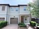 Charming townhome featuring a single-car garage, and brick-paver walkway nestled in a serene, landscaped neighborhood at 1308 Shinnecock Hills Dr, Davenport, FL 33896