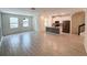 Spacious living area featuring modern tile floors, an open floor plan and a kitchen at 1308 Shinnecock Hills Dr, Davenport, FL 33896