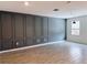 Stylish living room features wood-look tile, a decorative accent wall and natural light at 1308 Shinnecock Hills Dr, Davenport, FL 33896