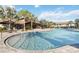 Beautiful community pool with inviting blue water, surrounded by palm trees and lounge areas at 1308 Shinnecock Hills Dr, Davenport, FL 33896