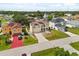 Aerial view showcasing a beautiful home with solar panels and a well-maintained yard in a serene neighborhood at 16 Sawfish Ct, Kissimmee, FL 34759