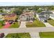 This aerial view highlights a lovely house with lush landscaping in a quiet residential neighborhood at 16 Sawfish Ct, Kissimmee, FL 34759