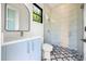 Modern bathroom with a glass shower, patterned floor, and blue vanity sink at 16 Sawfish Ct, Kissimmee, FL 34759