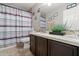 Bathroom featuring a double sink vanity, a shower with striped curtain, and tile floors at 16 Sawfish Ct, Kissimmee, FL 34759