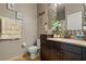 Charming bathroom features a dark wood vanity, decorative mirror, and stylish accessories at 16 Sawfish Ct, Kissimmee, FL 34759
