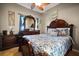 Spacious bedroom boasts a wooden bed frame, patterned bedding, and a matching dresser with mirror at 16 Sawfish Ct, Kissimmee, FL 34759