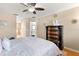 Cozy bedroom featuring a ceiling fan, elegant dresser, and comfortable bed with a patterned comforter at 16 Sawfish Ct, Kissimmee, FL 34759