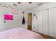 Cozy bedroom featuring hardwood floors, a closet, and pink bed at 16 Sawfish Ct, Kissimmee, FL 34759