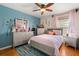 Bright bedroom with blue accent wall, lots of decor, and nice wood flooring at 16 Sawfish Ct, Kissimmee, FL 34759