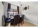 Dining room with a dark wood table, dark upholstered chairs, and large window with brown curtains at 16 Sawfish Ct, Kissimmee, FL 34759