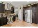 Modern kitchen showcasing stainless steel appliances, dark cabinetry, and a beautiful stone backsplash at 16 Sawfish Ct, Kissimmee, FL 34759