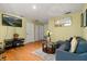 Living room with a large tv, wood floors, contemporary furniture, and decorations at 16 Sawfish Ct, Kissimmee, FL 34759