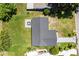 Overhead view of the house showing the lush lawn, surrounding trees, and the driveway at 17 S Flag Ct, Kissimmee, FL 34759