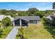 Attractive single-story home with a well-maintained yard and a sleek black and white exterior design at 17 S Flag Ct, Kissimmee, FL 34759