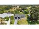 Single-story home with a sleek black and white exterior nestled among lush greenery at 17 S Flag Ct, Kissimmee, FL 34759
